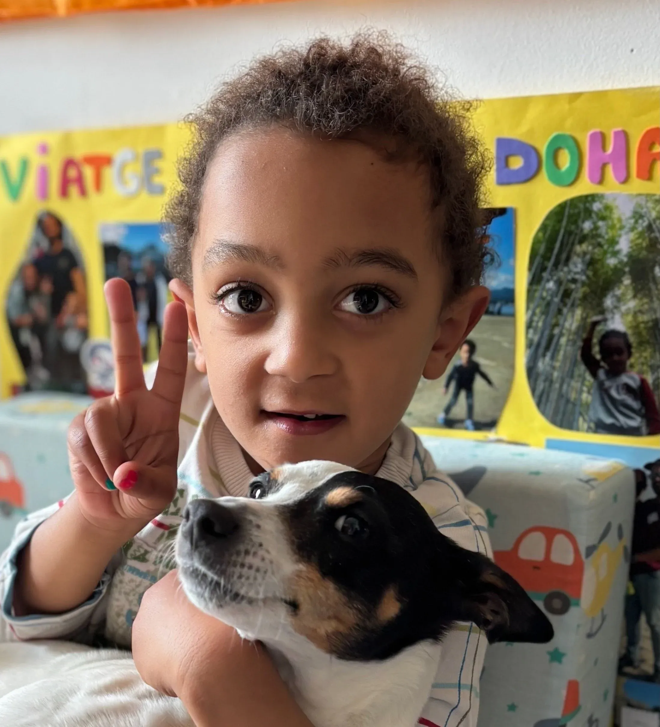 Martí smiling with his family dog